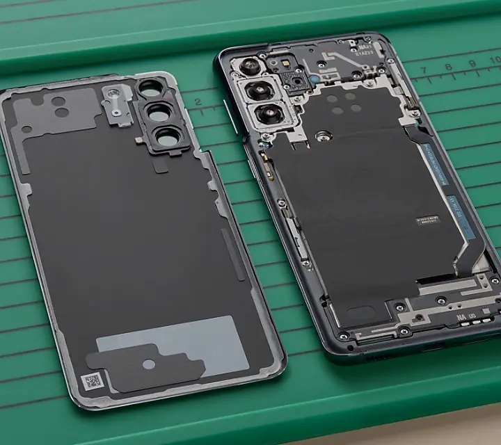 Technician repairing a Samsung smartphone in a professional repair shop